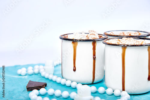 Hot chocolate with marshmallow candies on wooden background.