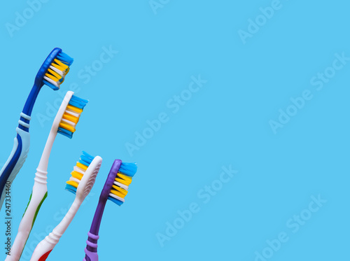 Flat lay composition with manual toothbrushes on white background.Toothbrush and toothpaste.op view, flat lay. Minimal concept, space for text.set of multicolored toothbrushes on white.
