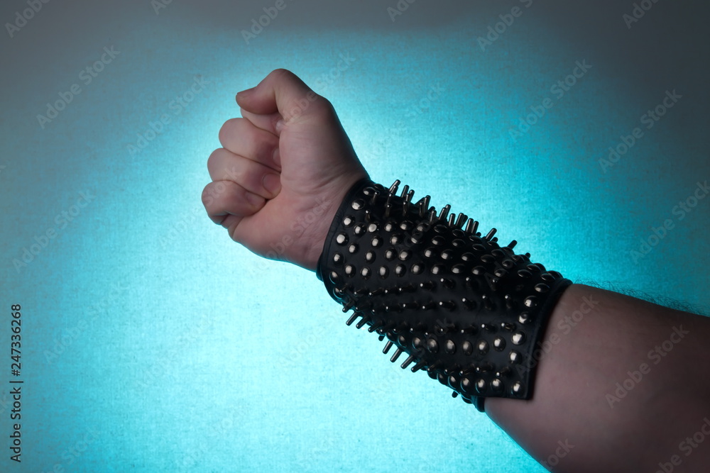 Hand of rocker in leather bracelet.Rock & roll, heavy  metal,gothic,punk,horns sign and fist.Hard style.Riveted. Stock Photo |  Adobe Stock
