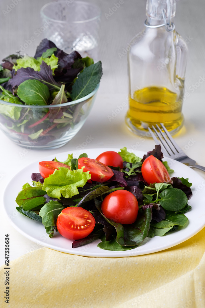 fresh colored cherry tomato salad with arugula, Basil, spinach, salad and olive oil dressing. selective focus. fresh colored cherry tomato salad with arugula, Basil, spinach, salad and olive oil dressing. selective focus.
