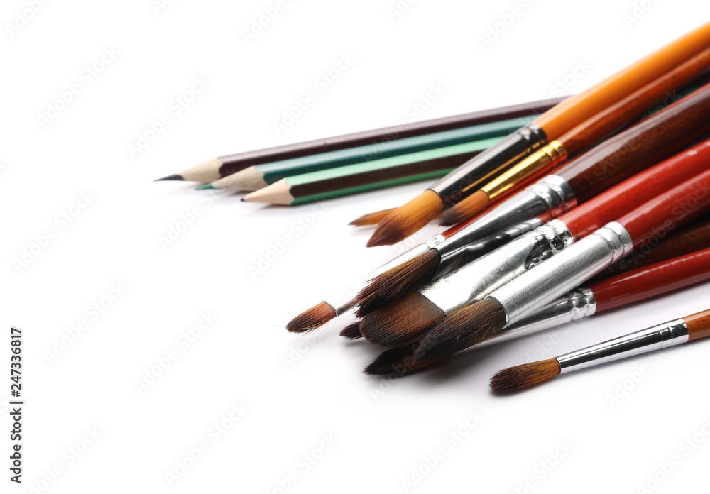 Paintbrushes and pencils isolated on white background