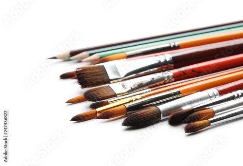 Paintbrushes and pencils isolated on white background