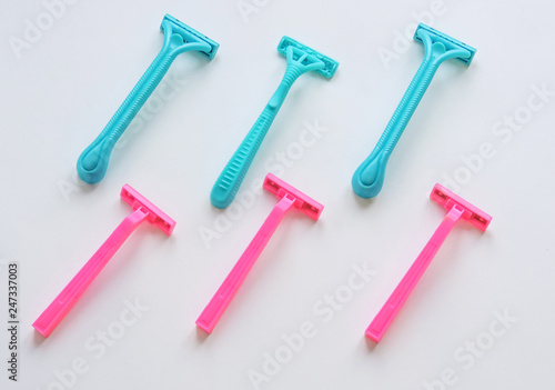 Removal of unwanted hair. top view. Concept of using razor. Shaving razor instrument. Skin care concept. Epilation hair removal. Flat lay, top view.multi-colored women's shaving razors isolated.