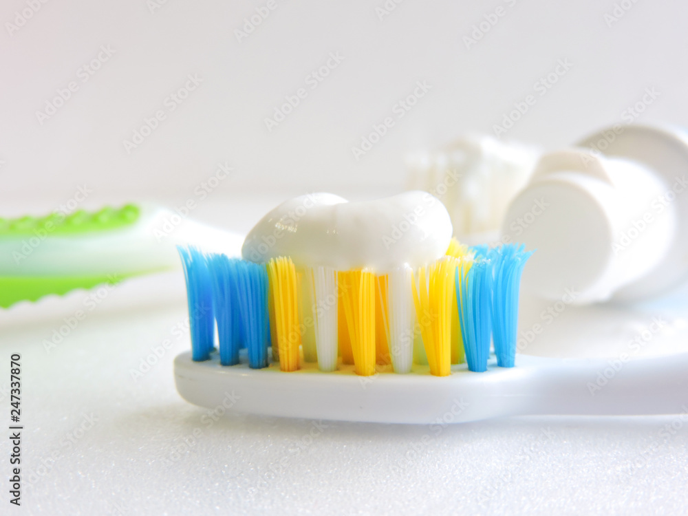 Flat lay composition with manual toothbrushes on white background.Toothbrush and toothpaste.op view, flat lay. Minimal concept, space for text.set of multicolored toothbrushes on white.