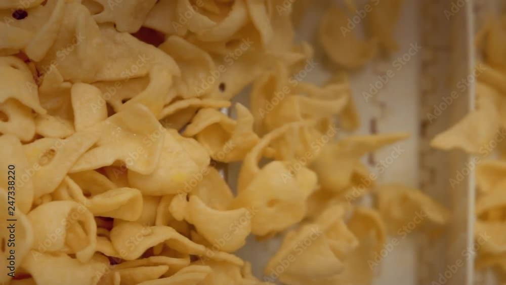 close up fried snacks production line factory slow motion close up fried snacks production line factory slow motion