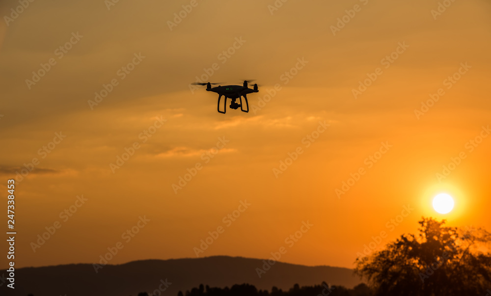 Drone shooting in the sky at sunset