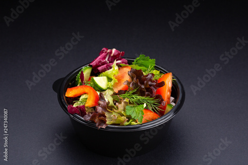 Vegetables and herbs plate mix snack on black background