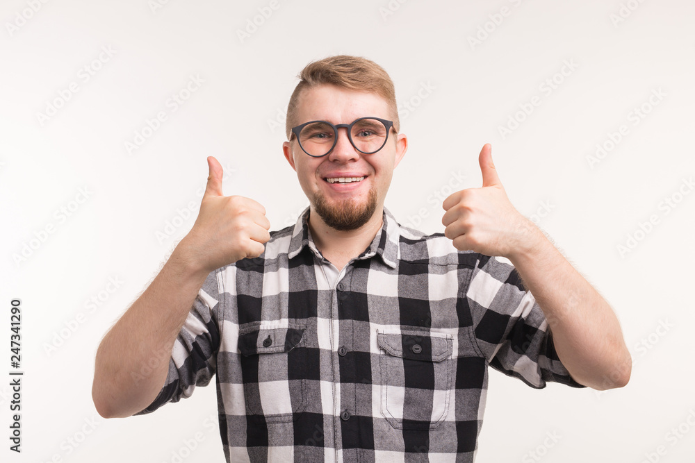 People and education concept - Smiling student man gesturing thumbs up over white background People and education concept - Smiling student man gesturing thumbs up over white background