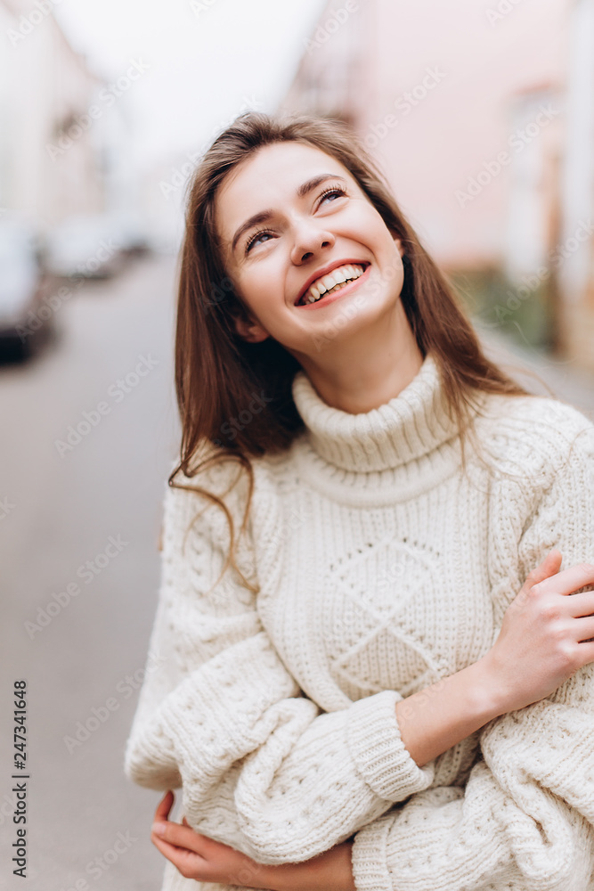 Portrait of young tender redhead young girl with healthy freckled skin wearing knitted scarf looking at camera with serious,pensive expression. Caucasian teen model with ginger hair posing outdoors Portrait of young tender redhead young girl with healthy freckled skin wearing knitted scarf looking at camera with serious,pensive expression. Caucasian teen model with ginger hair posing outdoors
