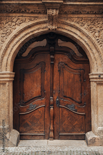 Old wooden door made of solid dark oak. Europe style