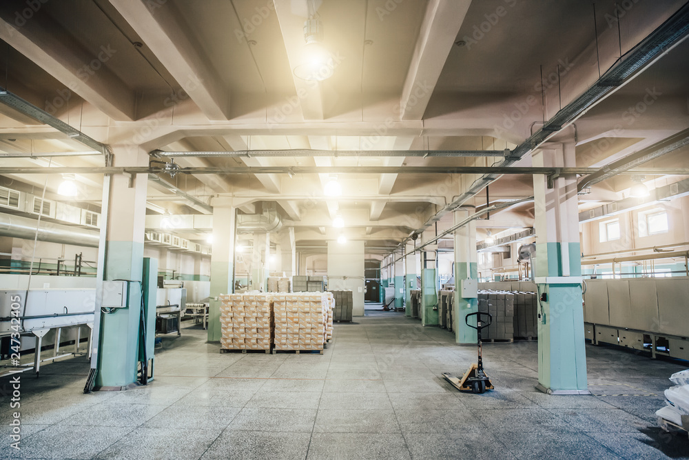 Warehouse in factory interior inside with boxes and other equipment Warehouse in factory interior inside with boxes and other equipment