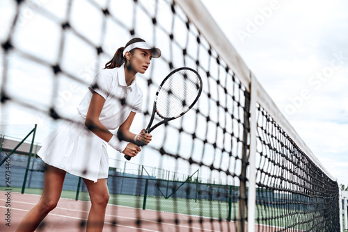 Concentration is your superpower. Beautiful woman is playing tennis © Friends Stock