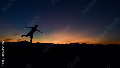 Silhouette of man doing walking at sunset, Concept lifestyle freedom vacation travel. © banphote
