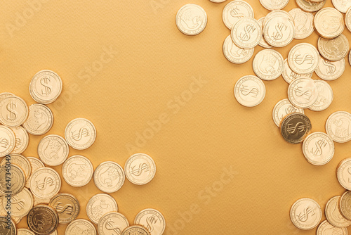 top view of golden coins with dollar signs isolated on orange with copy space, st patrick day concept