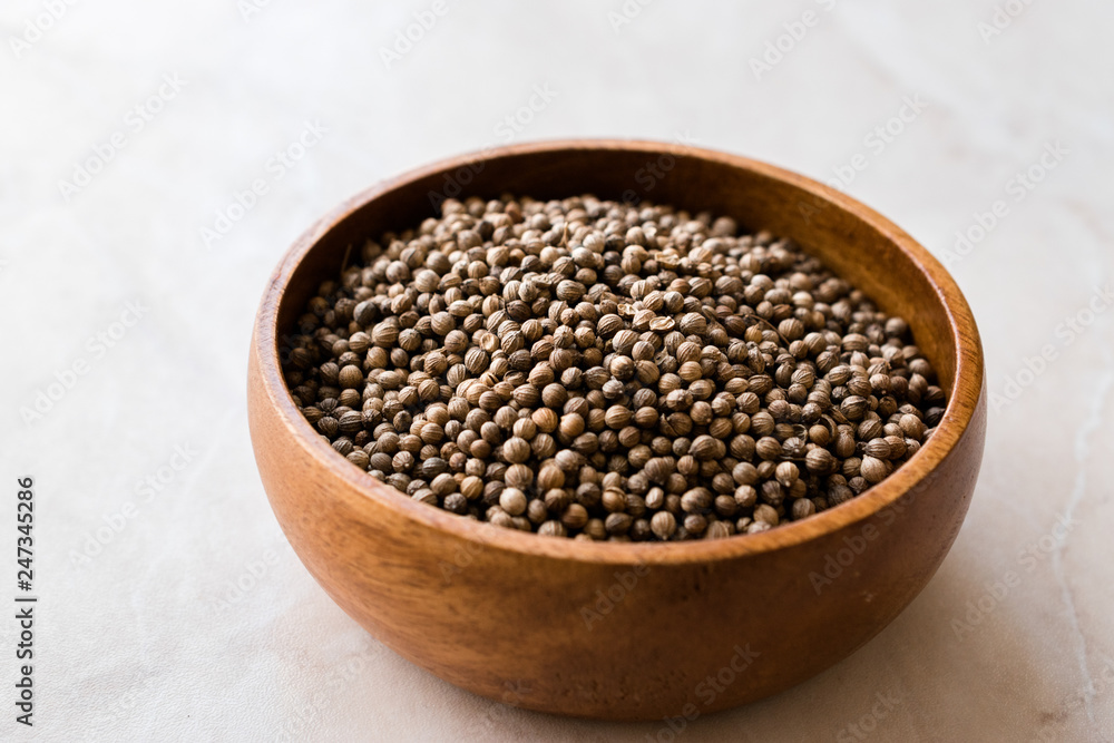 Organic Dried Coriander Seeds in Wooden Bowl. Organic Dried Coriander Seeds in Wooden Bowl.