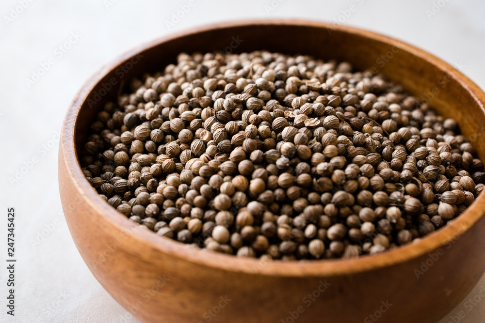 Organic Dried Coriander Seeds in Wooden Bowl. Organic Dried Coriander Seeds in Wooden Bowl.