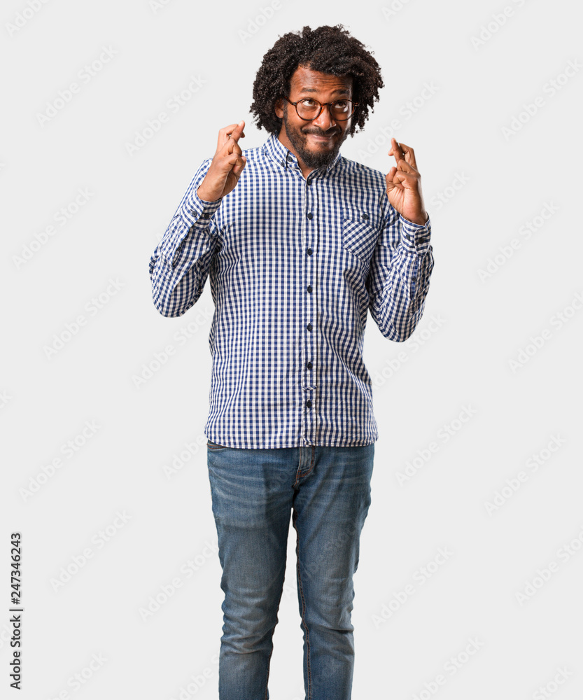 Handsome business african american man crossing his fingers, wishes to be lucky for future projects, excited but worried, nervous expression closing eyes Handsome business african american man crossing his fingers, wishes to be lucky for future projects, excited but worried, nervous expression closing eyes