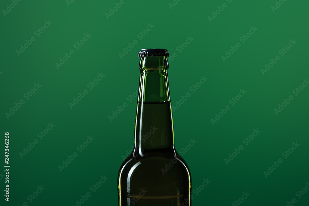 beer bottle isolated on green with copy space, st patrick day concept beer bottle isolated on green with copy space, st patrick day concept
