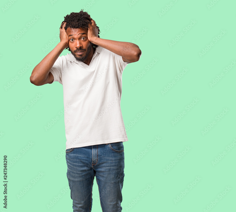 Handsome african american frustrated and desperate, angry and sad with hands on head Handsome african american frustrated and desperate, angry and sad with hands on head