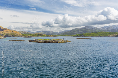 Navigating to Tjotta between small islets with the ferry from Forvik to Tjotta photo