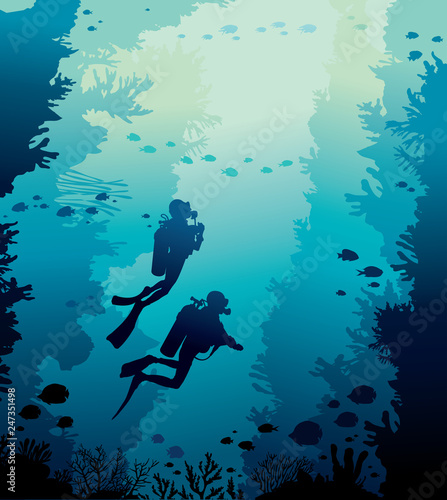 Scuba diver, coral reef, school of fish and sea.