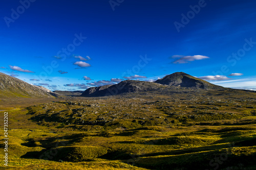 Highlands With Mountains And Spectacular Sunlit Valley near Durness And Rhiconich In Scotland photo