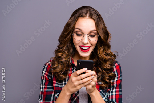 Close up portrait of amazing beautiful wavy she her lady hold telephone hands arms wondered read reader education news wearing checkered plaid shirt clothes isolated grey background