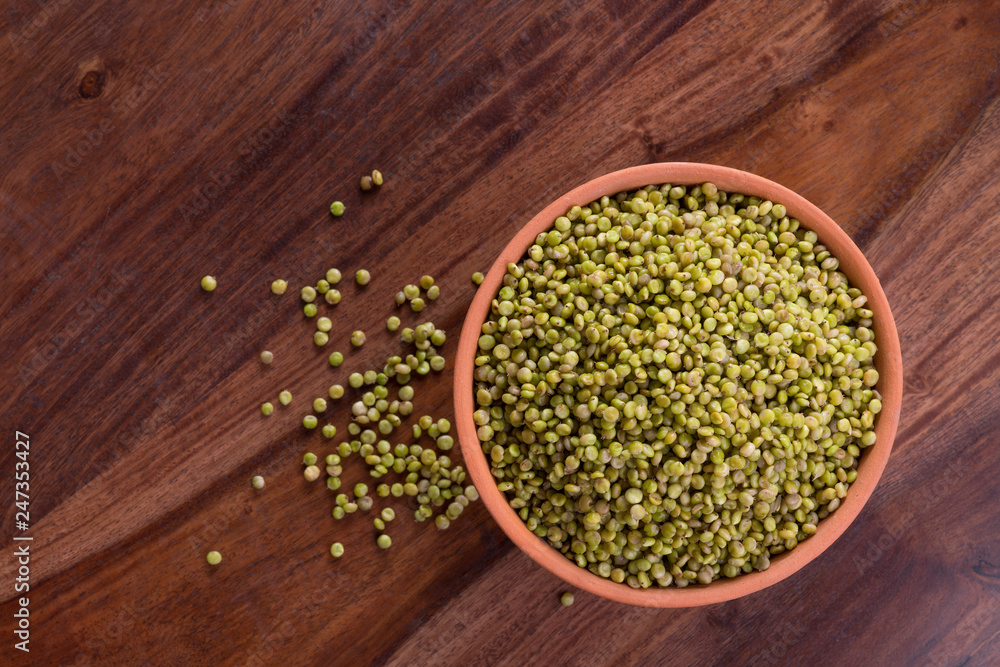 Top View of Fresh Green Tender Sorghum in a Earthen Bowl on Wooden Background Top View of Fresh Green Tender Sorghum in a Earthen Bowl on Wooden Background