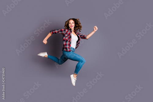 Full length body size view photo fly high beautiful she her girl rushing for black friday sale discount wearing casual checkered plaid shirt jeans denim isolated grey background