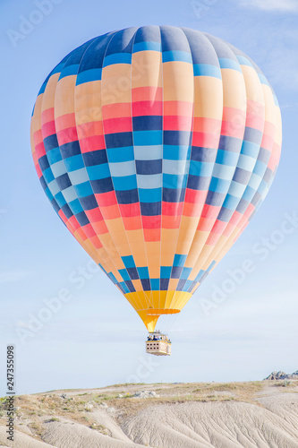 colourful hot air balloon floating over the valley in Turkey, Cappadocia  © lisinama