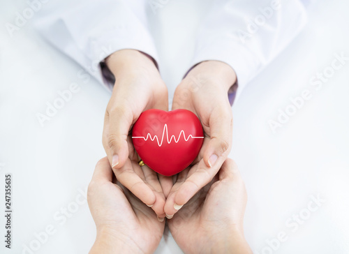 Doctor hands holding red heart. photo