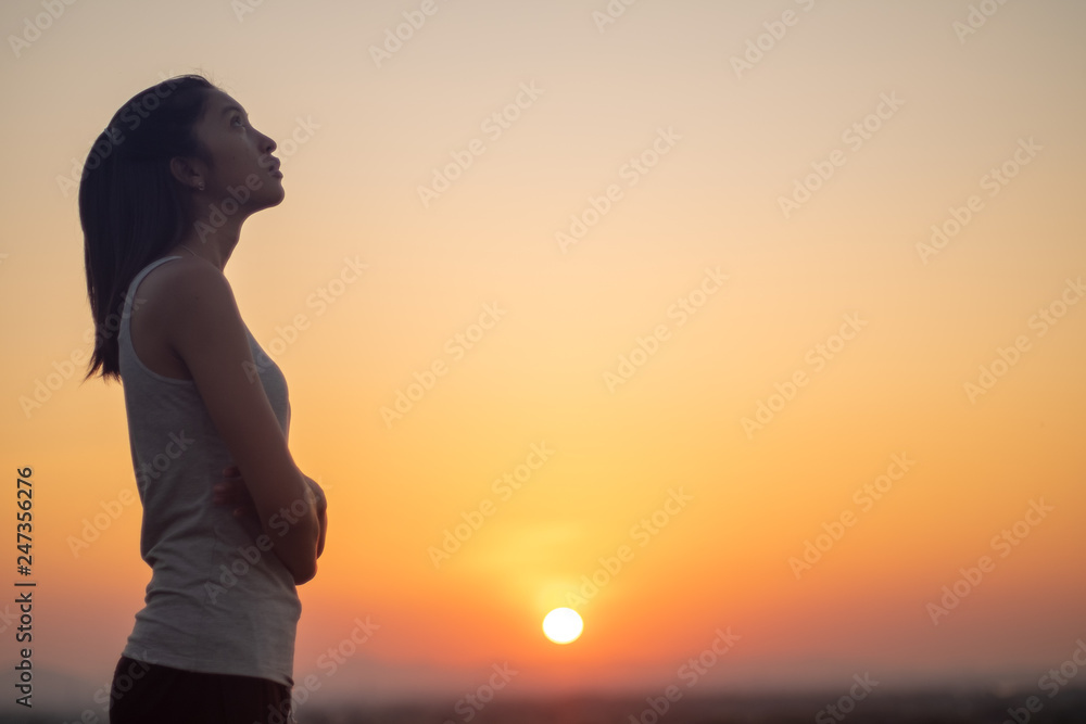 Lonely young asian woman at sunset