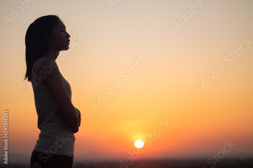 Lonely young asian woman at sunset