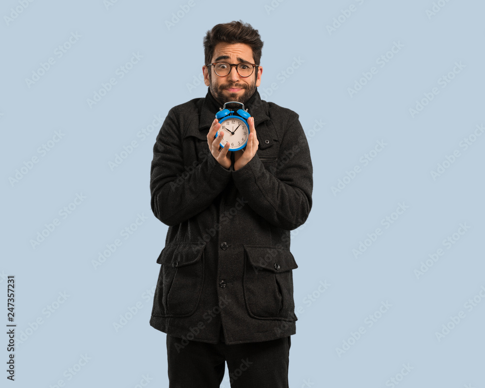 young man holding an clock young man holding an clock