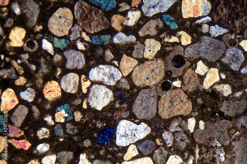 Photography Thin section of concrete under a microscope and in cross polarized light