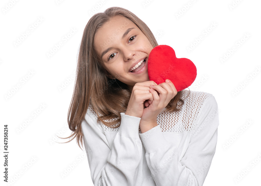 Happy Valentines Day. Cute young Teen Girl in Love with Red plush Heart in her hands. Smiling Child looking at camera, isolated on white background. Happy Valentines Day. Cute young Teen Girl in Love with Red plush Heart in her hands. Smiling Child looking at camera, isolated on white background.