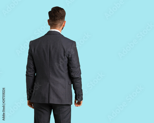 Fotografie Young handsome business man from behind, looking back