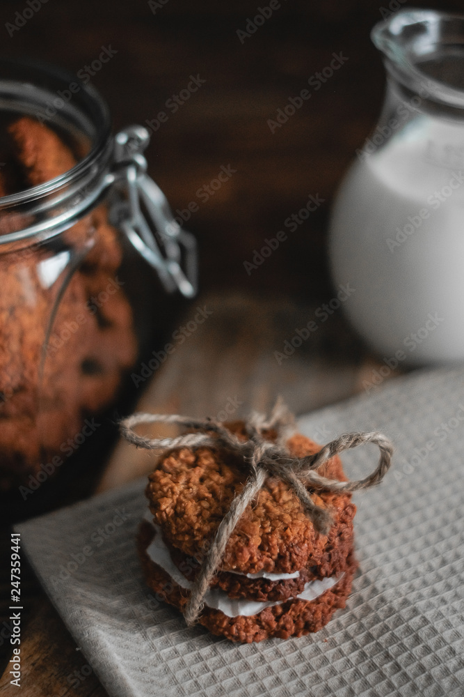 Homemade oatmeal cookies on wooden board on old table background. Healthy Food Snack Concept Homemade oatmeal cookies on wooden board on old table background. Healthy Food Snack Concept
