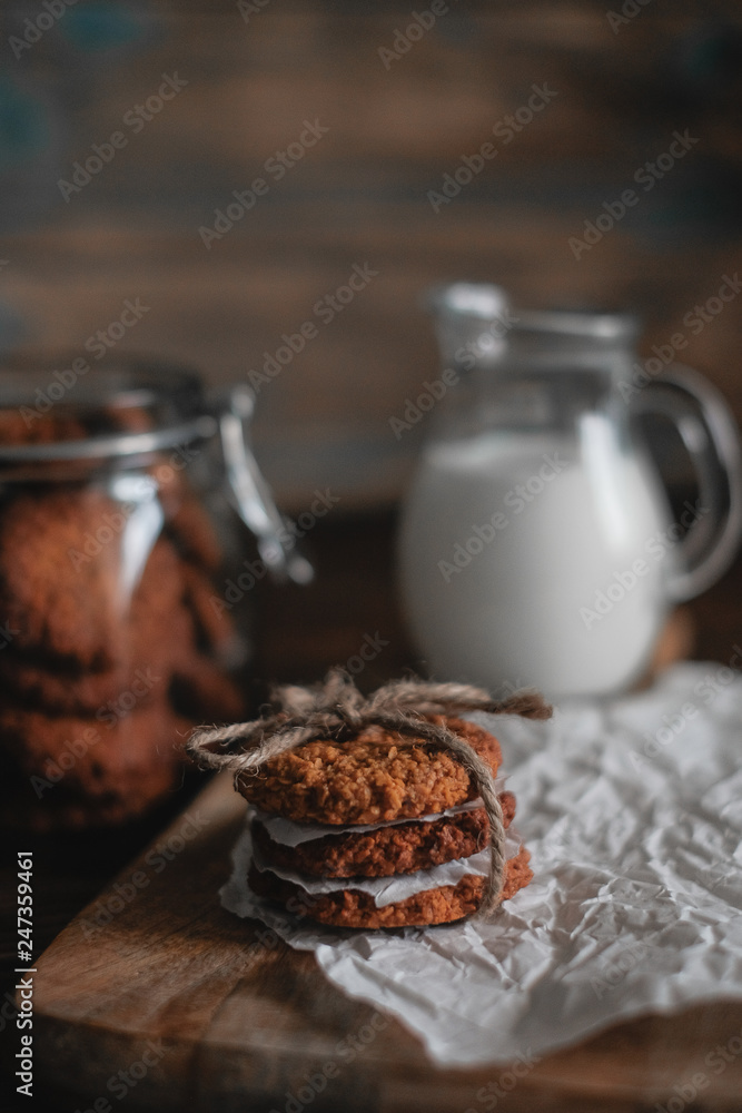 Homemade oatmeal cookies on wooden board on old table background. Healthy Food Snack Concept Homemade oatmeal cookies on wooden board on old table background. Healthy Food Snack Concept