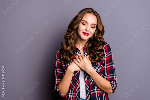 Portrait of nice-looking cute attractive lovely well-groomed charming cheerful wavy-haired lady keeping hands on breast chest closed eyes isolated over gray pastel background