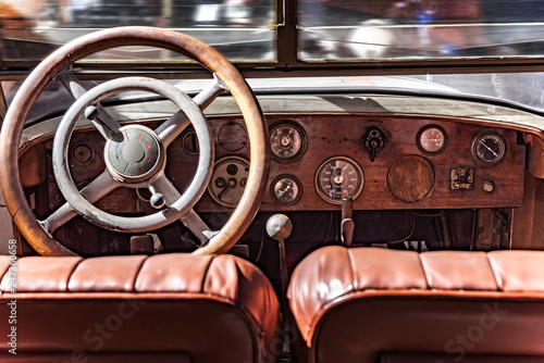 Cabin from inside a retro car. Wooden dashboard and steering wheel. © Denis Rozhnovsky