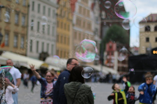 Flying beautiful, soap bubbles. Warm, pleasant, spring day. Family atmosphere in the outdoors. Active rest, weekend in the city. Relaxing people. Great fun outside. Variety of colors. Freedom, leisure