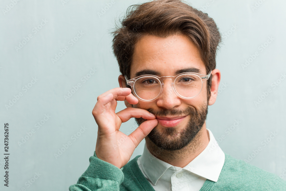 Young handsome entrepreneur man face closeup keeping a secret or asking for silence, serious face, obedience concept Young handsome entrepreneur man face closeup keeping a secret or asking for silence, serious face, obedience concept