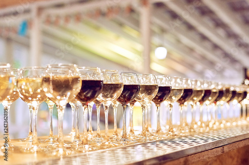 wine glasses on corporate party celebration with lights on background