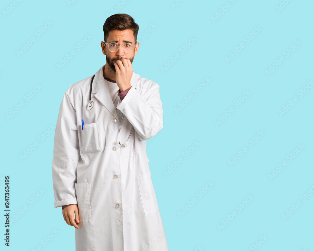 Young doctor man biting nails, nervous and very anxious Young doctor man biting nails, nervous and very anxious