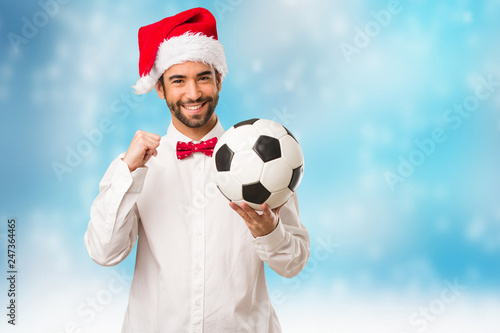 Young man wearing a santa claus hat on Christmas day © Asier