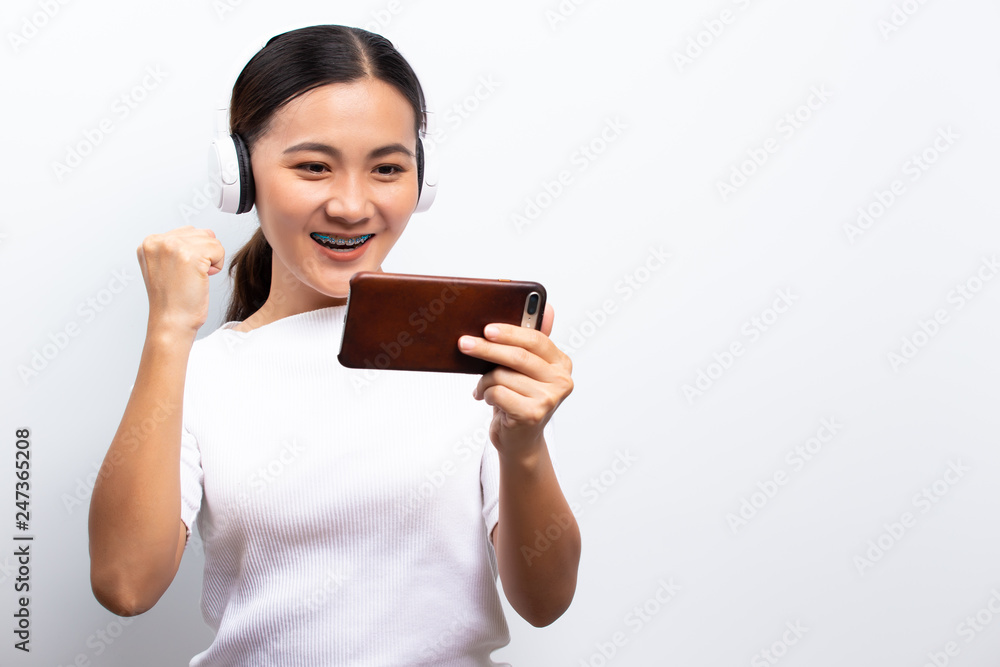 Happy woman playing to the game from smartphone Happy woman playing to the game from smartphone