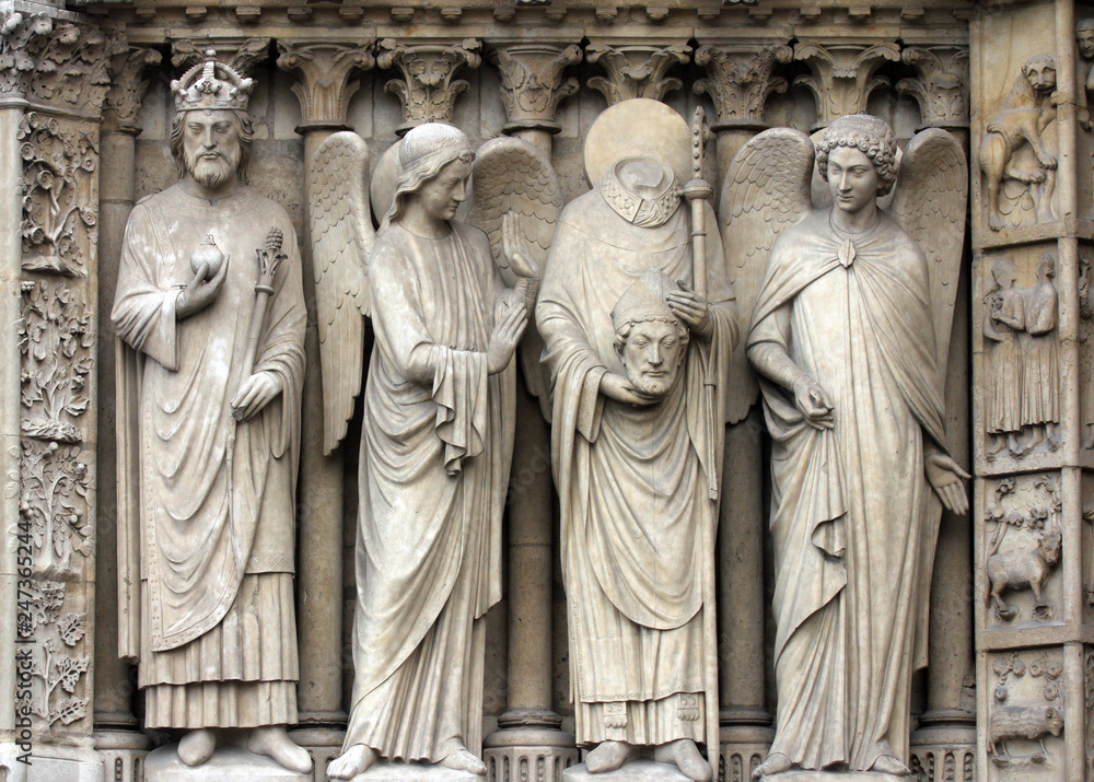 Paris, Notre-Dame cathedral, portal of the Virgin. From left to right: Emperor Constantine, an angel, Saint Denis holding his head, and another angel.