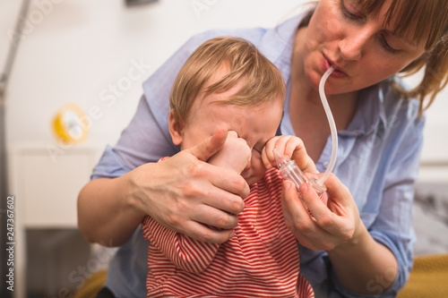 Photography toddler boy does not want to clean his nose