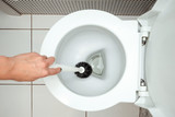 Close-up, Female hand washes a toilet brush. The concept of cleanliness in the house, hygiene, toilet, microbes.
